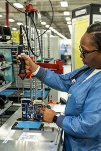 Manufacturer at L3Harris assembling electronics with LightGuide projected augmented reality work instructions and smart torque tool